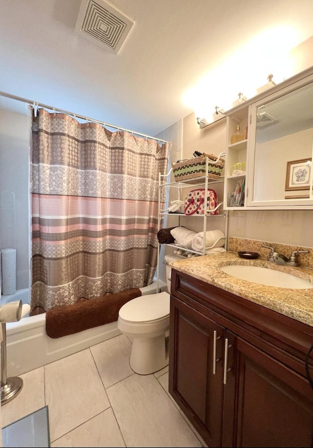 full bathroom with shower / bath combo with shower curtain, tile patterned flooring, vanity, and toilet