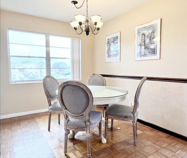 dining space with light parquet floors and a notable chandelier