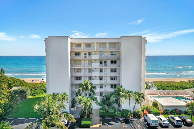 view of property featuring a water view and a beach view