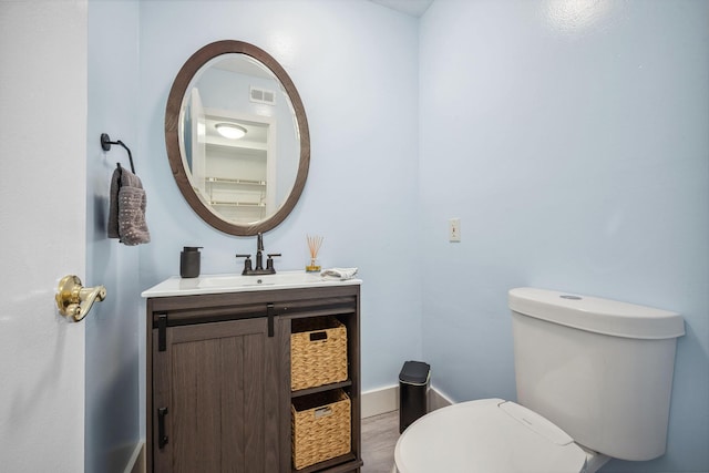 bathroom featuring toilet and vanity