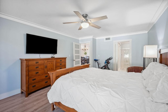 bedroom featuring ceiling fan with notable chandelier, ensuite bath, light wood-type flooring, and ornamental molding