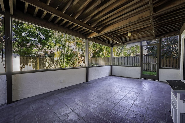 unfurnished sunroom featuring a water view