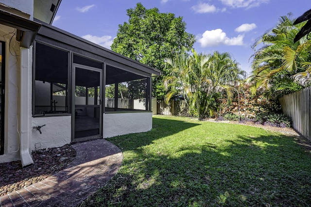 view of yard with a sunroom