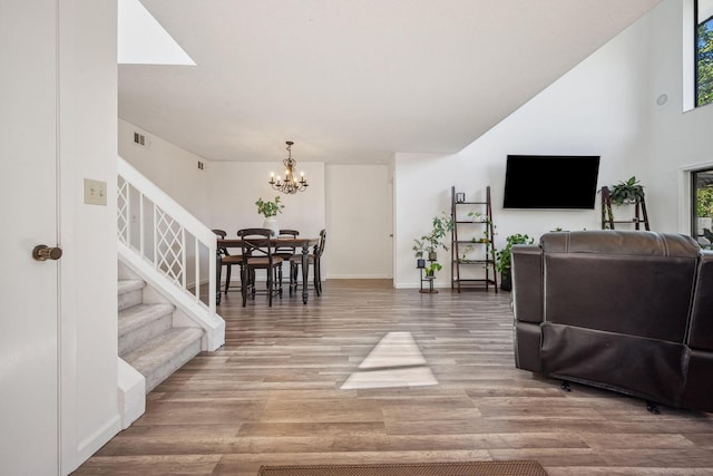 living room with a notable chandelier and wood-type flooring