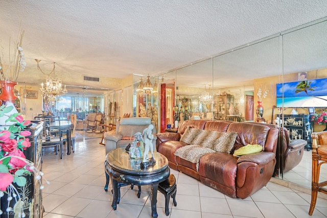 tiled living room with a chandelier and a textured ceiling