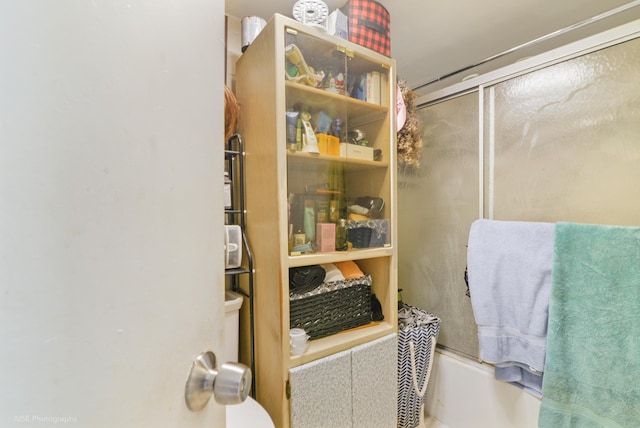 bathroom with shower / bath combination with glass door