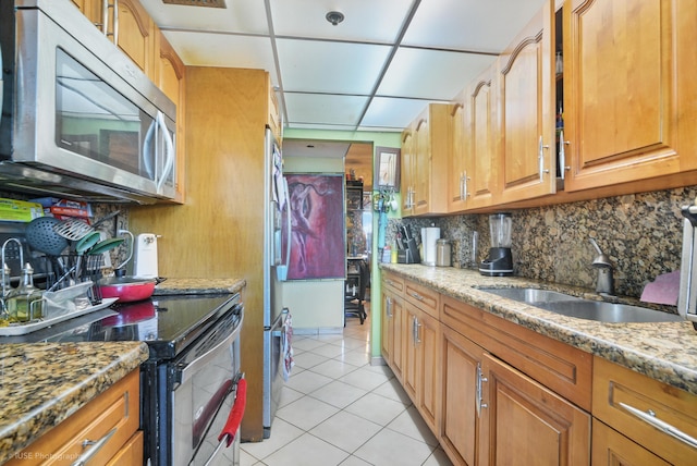 kitchen with tasteful backsplash, a drop ceiling, sink, light tile patterned floors, and black range with electric stovetop