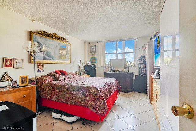 tiled bedroom featuring a textured ceiling