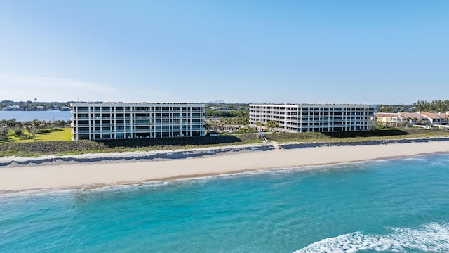 drone / aerial view featuring a water view and a view of the beach