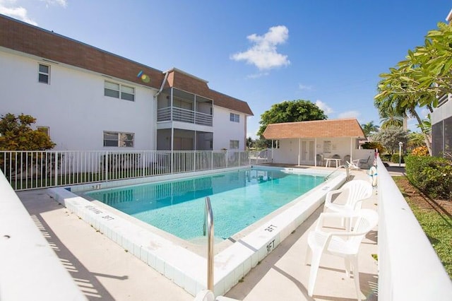 view of swimming pool featuring an outbuilding