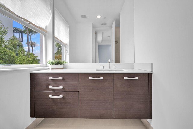 bathroom with tile patterned floors and vanity