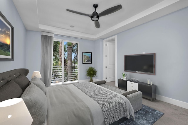 bedroom with carpet, ceiling fan, and a tray ceiling