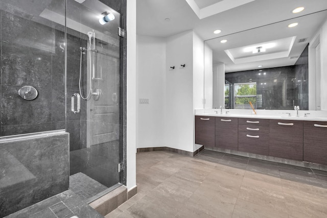 bathroom with vanity, a tray ceiling, and walk in shower