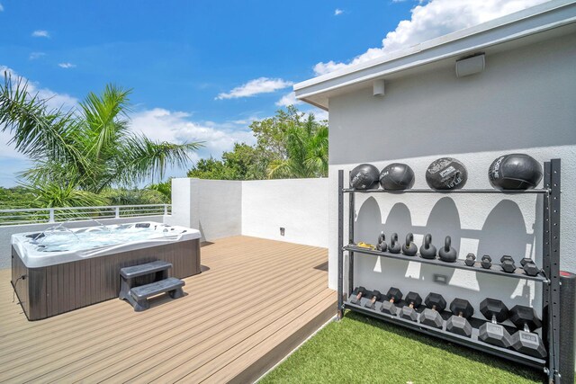 wooden deck featuring a hot tub