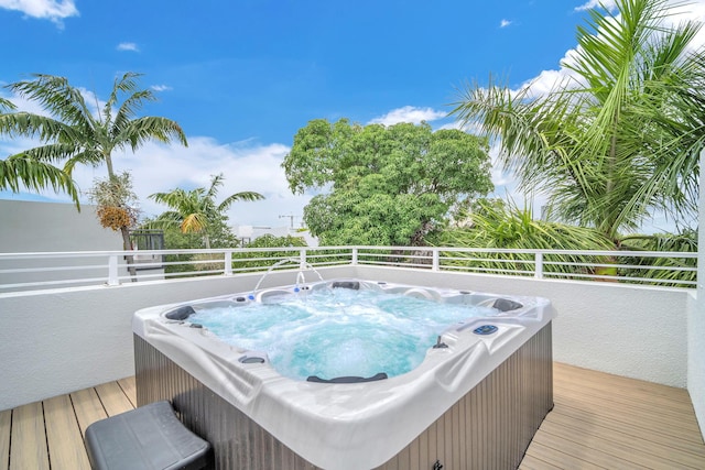 wooden deck with a hot tub