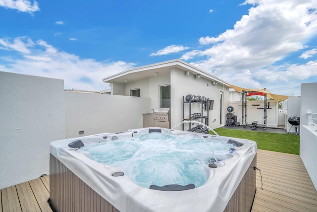 wooden terrace featuring a hot tub