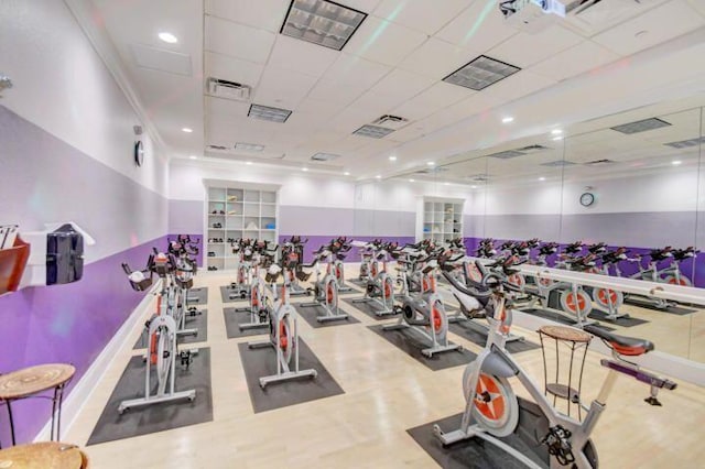 workout area featuring hardwood / wood-style flooring and a paneled ceiling