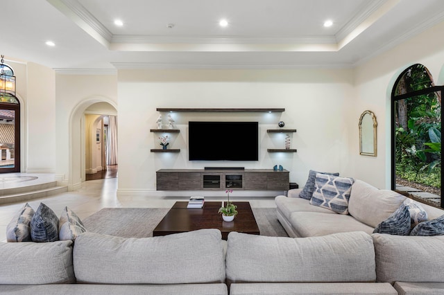 living room featuring crown molding and a tray ceiling