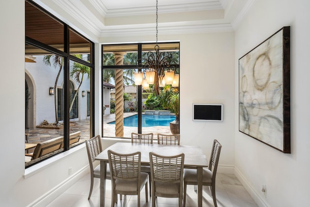 dining room featuring an inviting chandelier, crown molding, and light tile patterned flooring