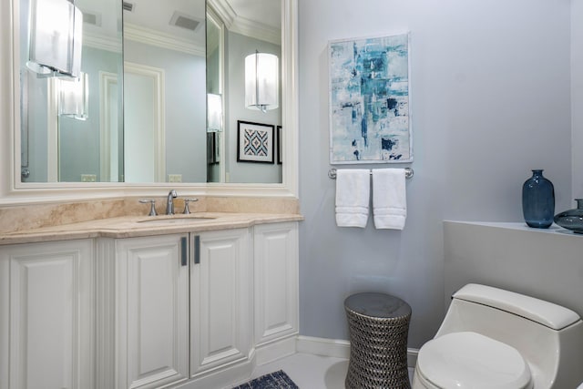 bathroom featuring ornamental molding, vanity, and toilet