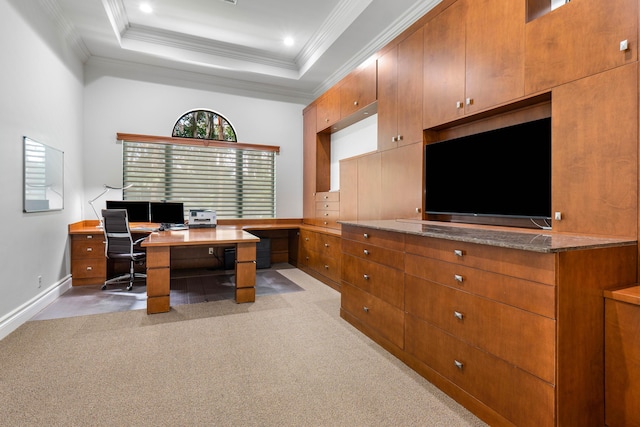 office area featuring crown molding, a raised ceiling, and light carpet