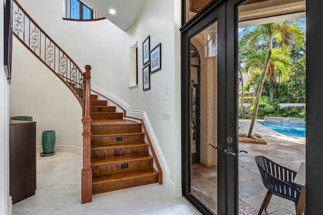 stairs with french doors