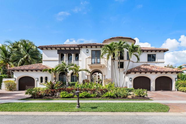 mediterranean / spanish-style house with a balcony and a garage