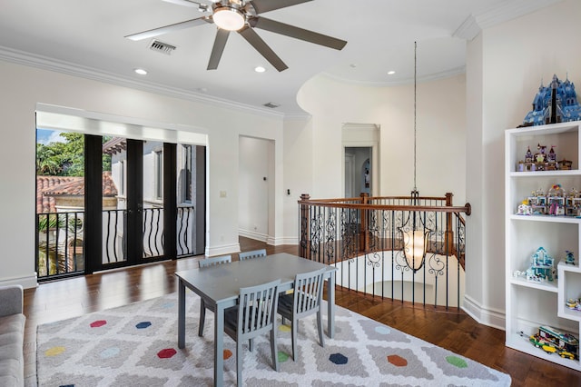 dining room featuring crown molding, dark hardwood / wood-style flooring, and ceiling fan with notable chandelier