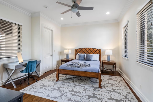 bedroom featuring crown molding, dark hardwood / wood-style floors, and multiple windows