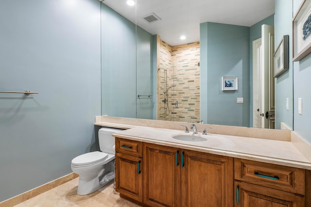 bathroom featuring vanity, toilet, a shower with shower door, and tile patterned flooring