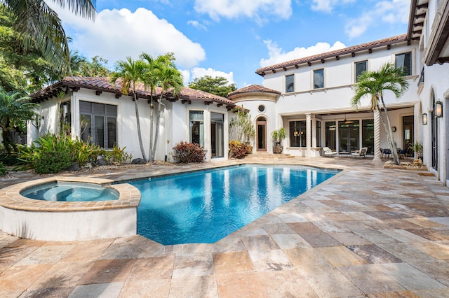 view of swimming pool featuring an in ground hot tub and a patio