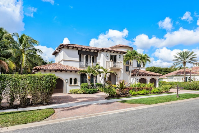 mediterranean / spanish-style house featuring a balcony and a garage