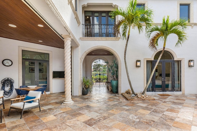 view of exterior entry featuring a patio and french doors