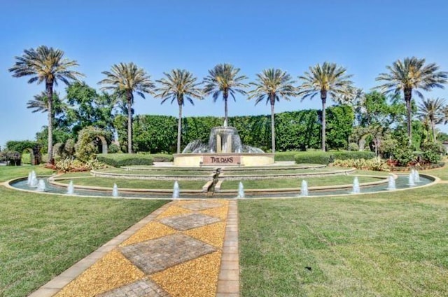 view of property's community with a lawn