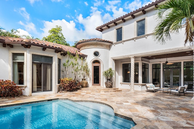 back of property featuring a patio and ceiling fan