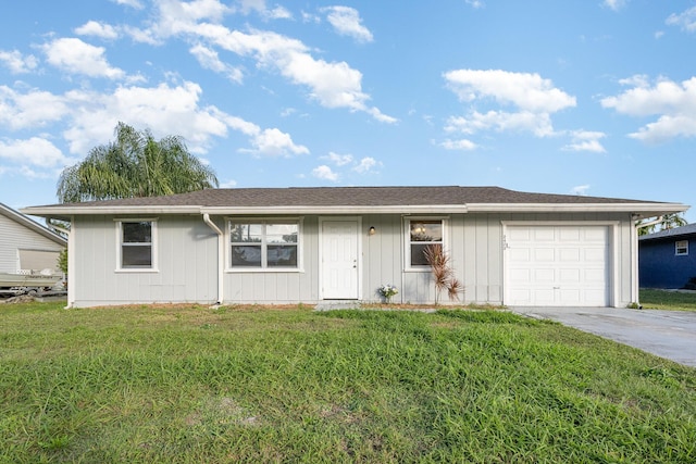 ranch-style house featuring a front lawn and a garage