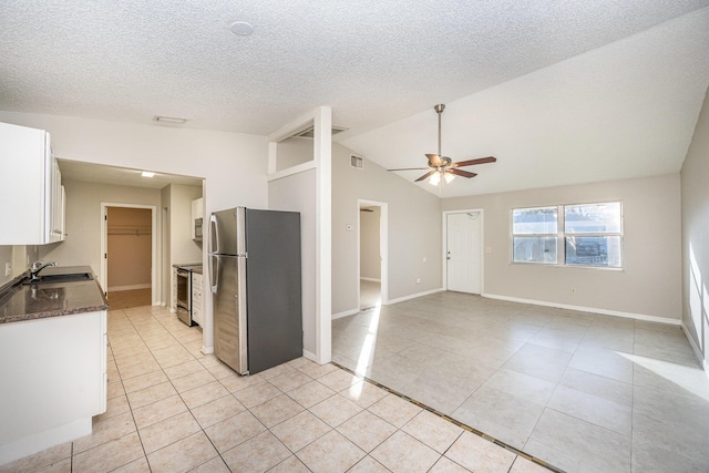 kitchen with ceiling fan, sink, stainless steel appliances, light tile patterned floors, and white cabinets