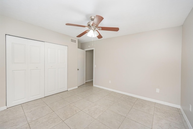 unfurnished bedroom featuring ceiling fan, light tile patterned flooring, and a closet