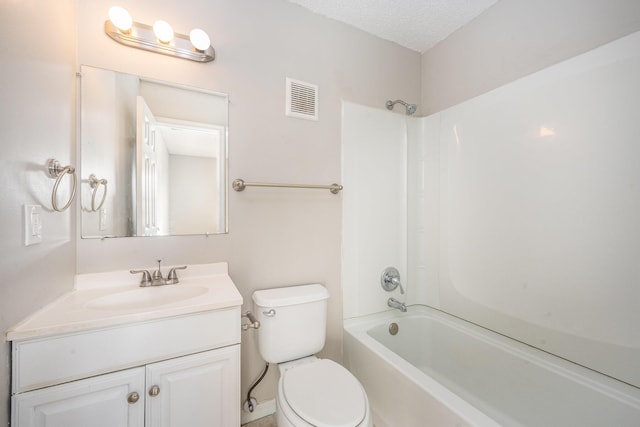 full bathroom featuring washtub / shower combination, vanity, a textured ceiling, and toilet