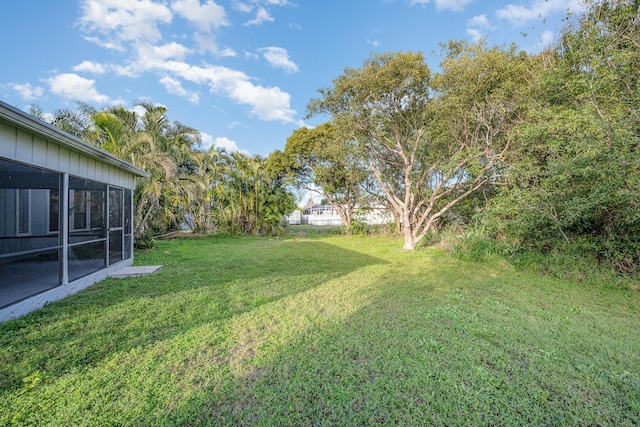 view of yard featuring a sunroom