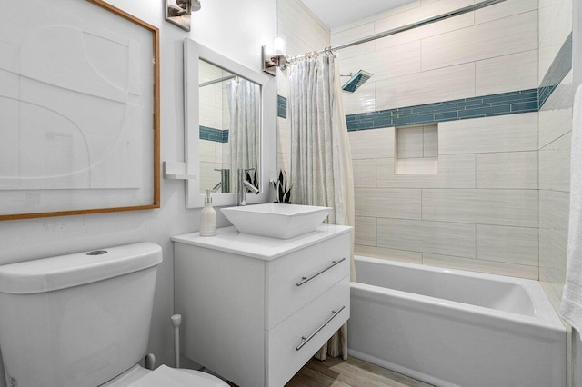 full bathroom featuring vanity, toilet, shower / bath combo with shower curtain, and wood-type flooring