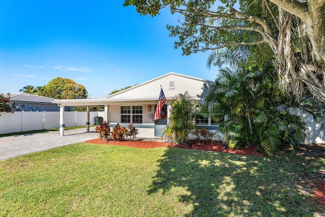 view of front of home featuring an attached carport, a front yard, fence, driveway, and stucco siding