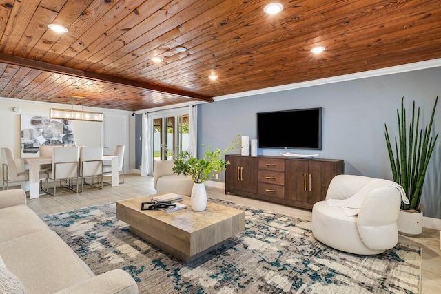 living room with wooden ceiling, an inviting chandelier, beamed ceiling, light wood-type flooring, and ornamental molding