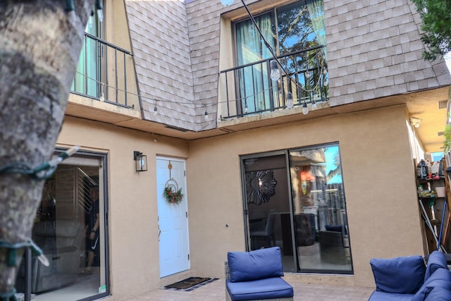 back of property with a patio and a balcony