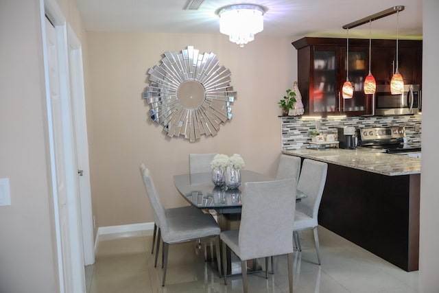 dining room featuring a chandelier and light tile patterned flooring