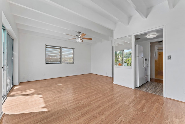 spare room with beam ceiling, light wood-type flooring, ceiling fan, and a healthy amount of sunlight