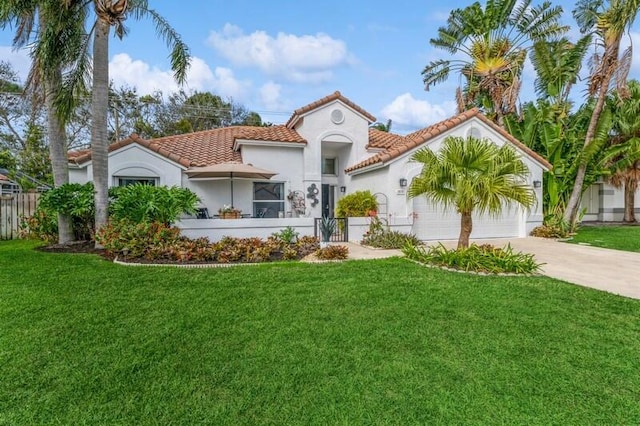 mediterranean / spanish home featuring a front lawn