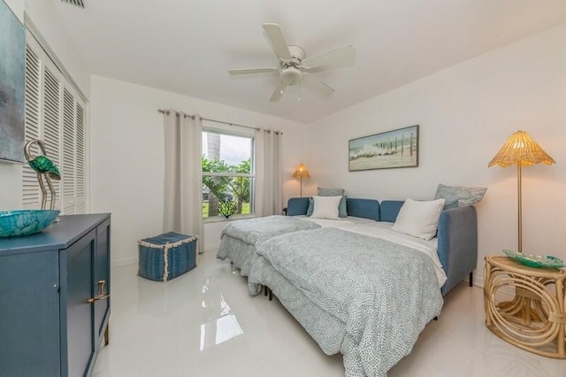 bedroom with ceiling fan and a closet