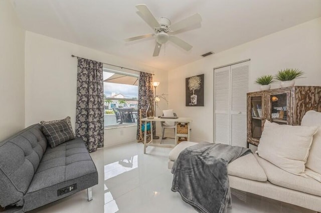 tiled living room featuring ceiling fan