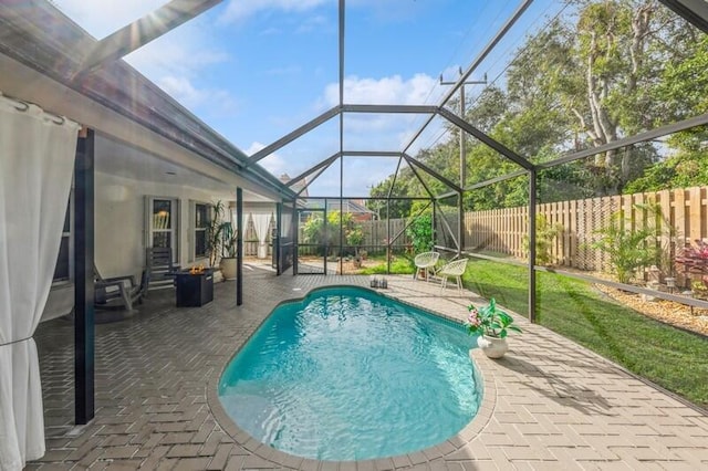 view of swimming pool featuring a patio area and a lanai